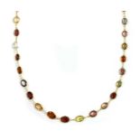 A gold assorted gemstone rivière necklace,