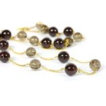 A gold garnet and smoky quartz necklace,