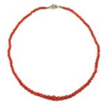 A single row graduated coral bead necklace,