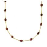 A gold garnet necklace,
