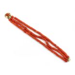 A three row uniform coral bead bracelet,