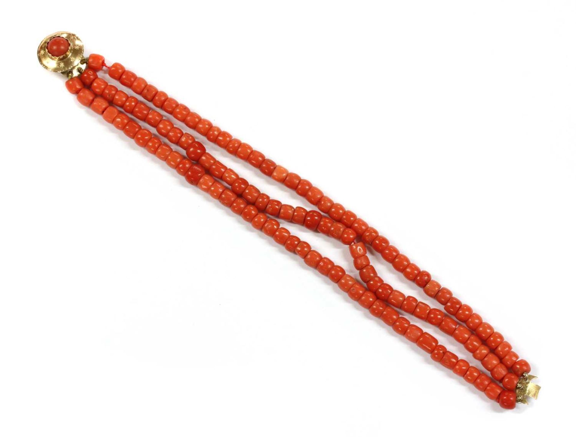 A three row uniform coral bead bracelet,