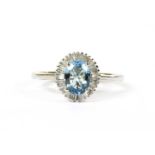 A white gold aquamarine and diamond cluster ring,