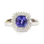 A 9ct white gold tanzanite and diamond double halo cluster ring,
