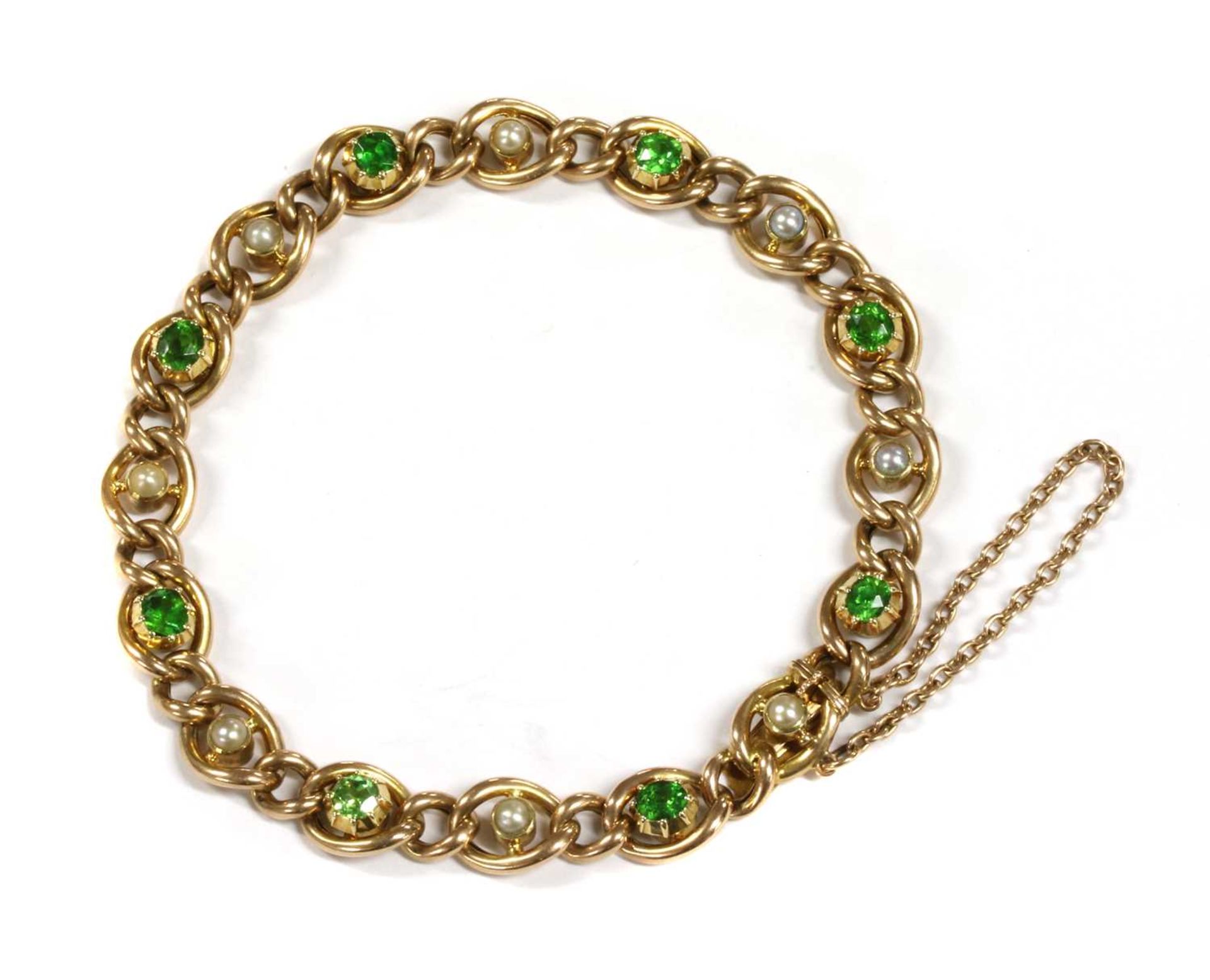 A Victorian gold demantoid garnet and split pearl curb bracelet,