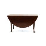 An oval mahogany two flap table