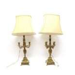 A pair of gilt metal and onyx table lamps