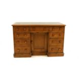 A Victorian stripped pine kneehole desk,