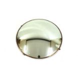 A convex circular wall mirror