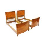 A pair of satinwood single beds,