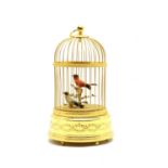A modern gilt singing birdcage music box