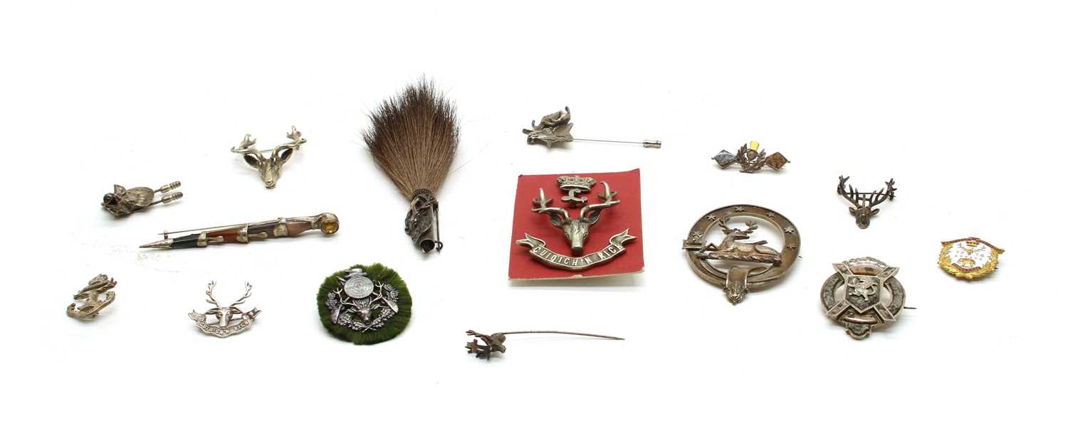 Ten various metal brooches and cap badges,