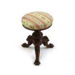 A Victorian carved walnut piano stool,