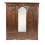 An Arts and Crafts oak wardrobe,