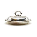 An oval silver entree dish and cover
