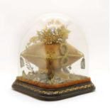 A Victorian square glass dome on a gilt work and ebonised base,
