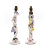 A pair of French faience caricature figural candlesticks,