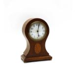 An Edwardian mantel clock and an oak tray