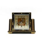 A black lacquered mantel clock,