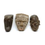 Three carved tribal masks,