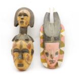Two painted and carved tribal masks,