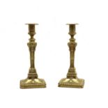 A pair of 19th century cast brass candlesticks of classical design,