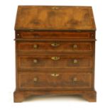 A yew, crossbanded and feather-banded bureau,