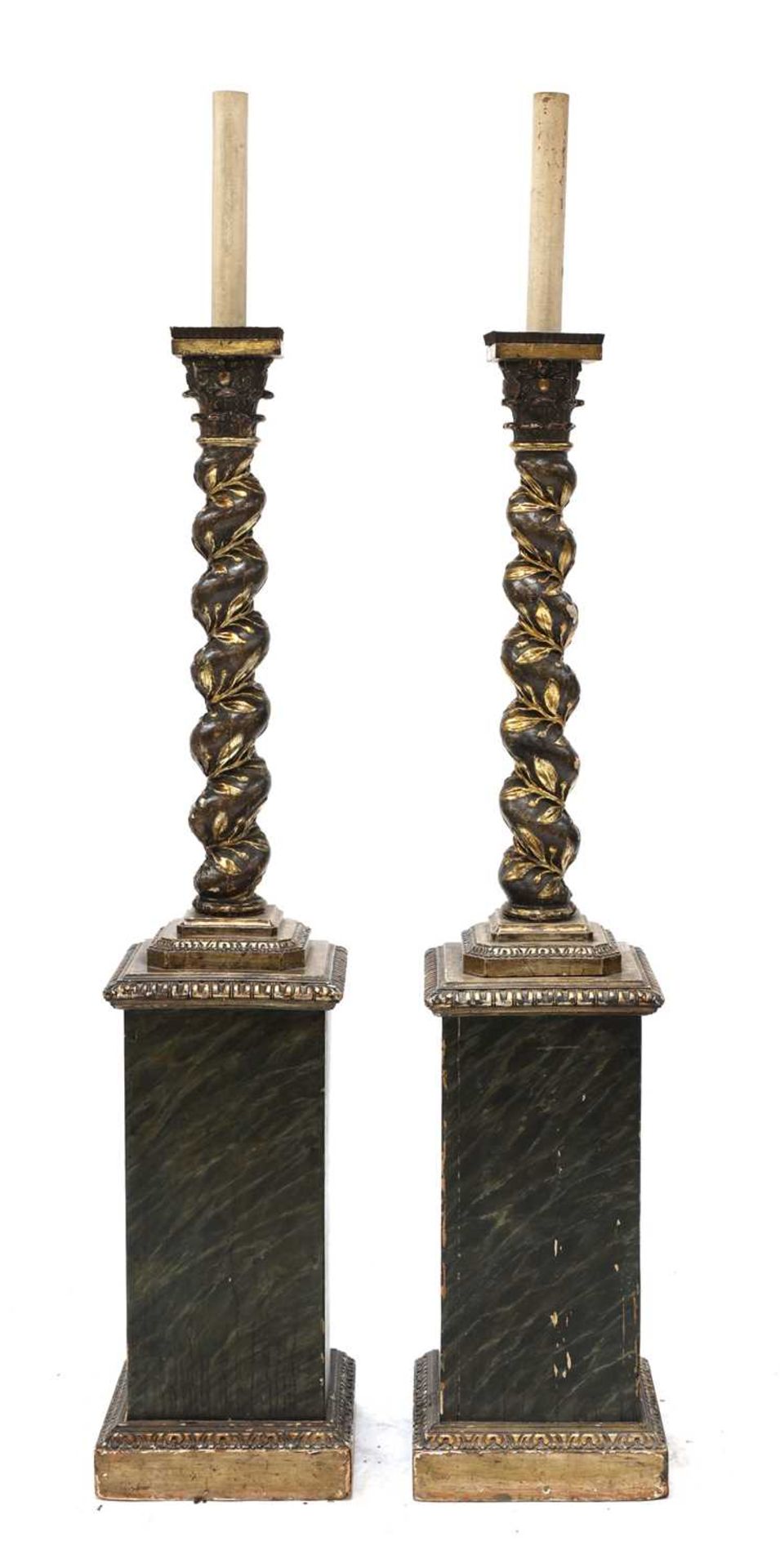 A pair of carved wooden lamp standards