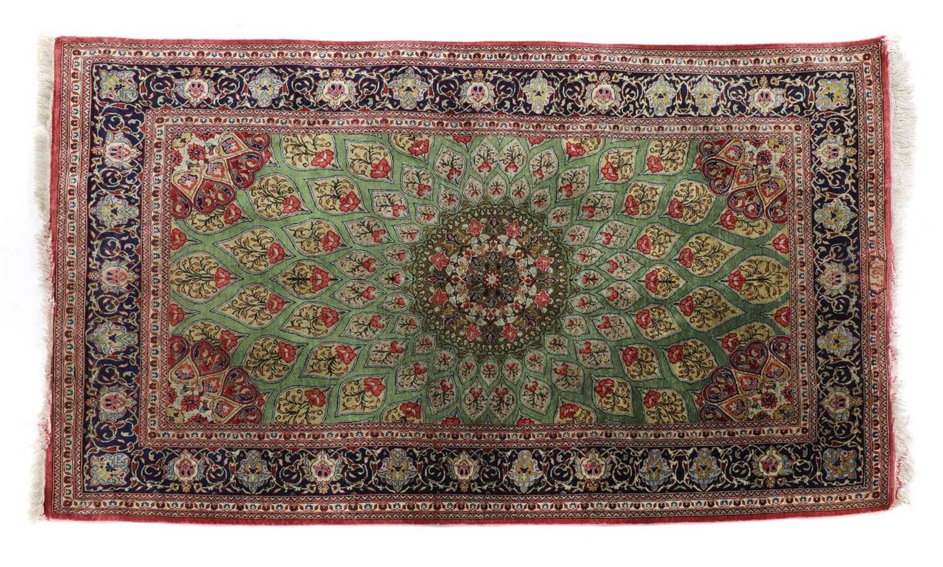 A Persian silk rug,