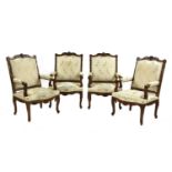 A set of four French Regency-style walnut elbow chairs,