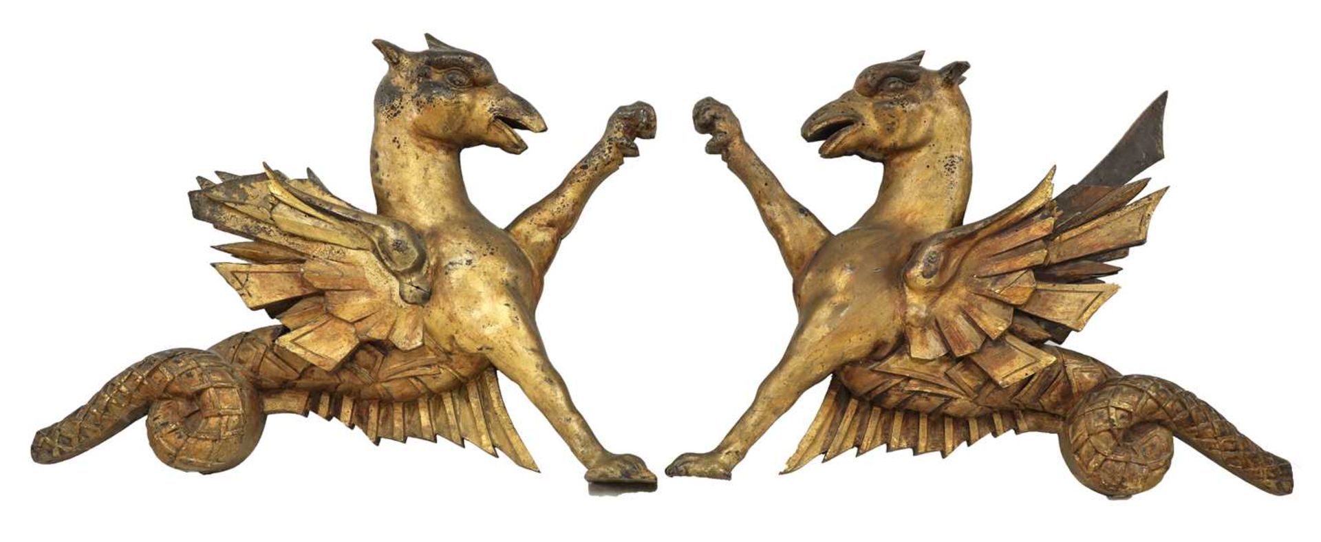 An opposing pair of carved giltwood dragon finials,