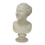 A white marble bust of a smiling young girl,