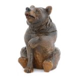 A Black Forest carved wooden bear tobacco jar,