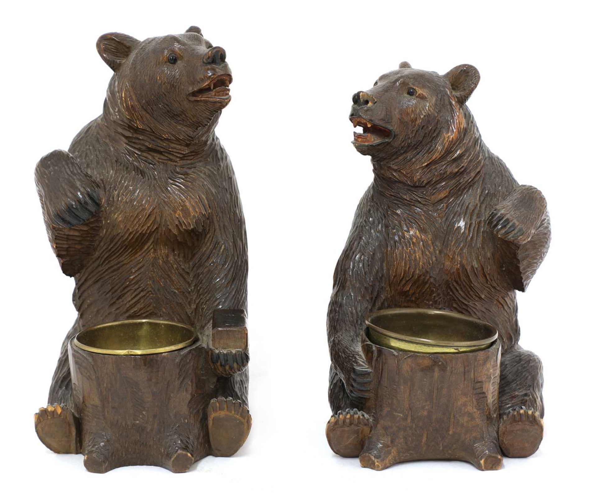 A near opposing pair of carved Black Forest bear ashtrays,