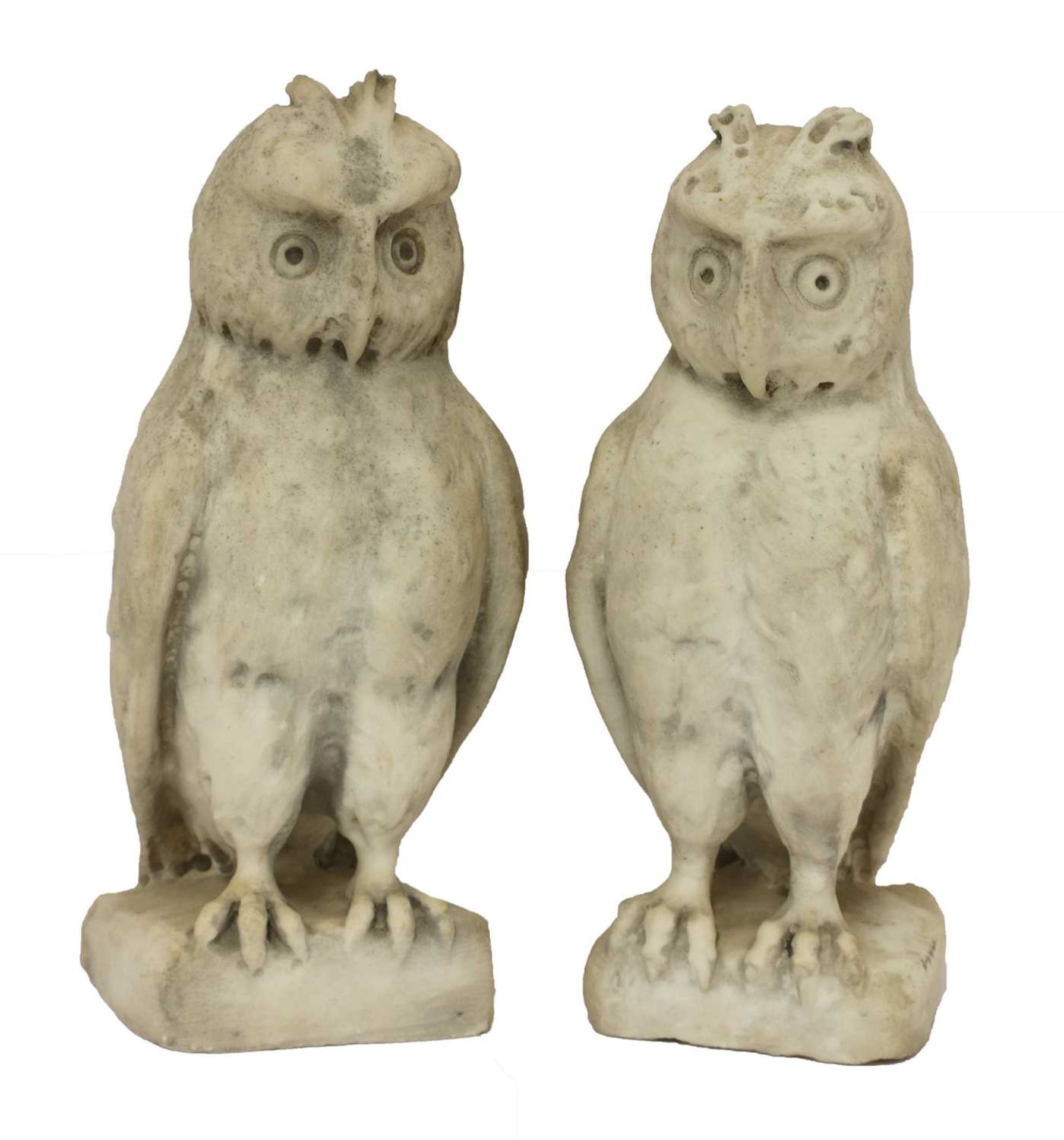 A pair of carved marble owls
