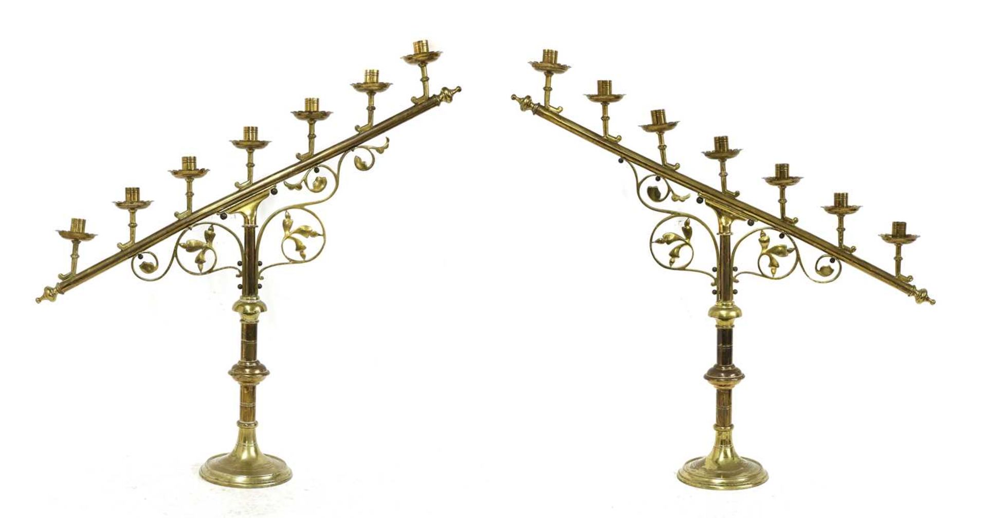 A pair of brass ecclesiastical candlesticks