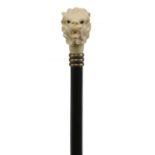 A carved ivory and ebonised walking stick,