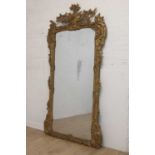 A large carved giltwood wall mirror