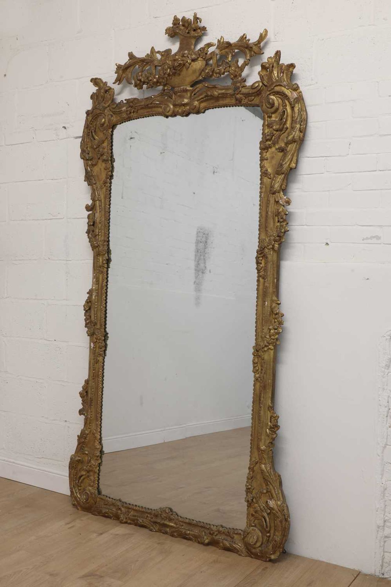 A large carved giltwood wall mirror