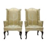 A pair of wingback armchairs,