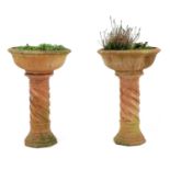 A pair of terracotta garden urns,