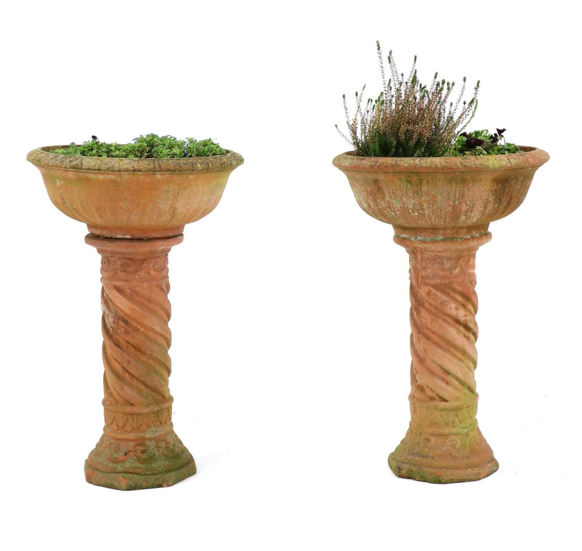 A pair of terracotta garden urns,