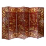 A large Chinese six-fold red-lacquered screen,