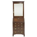 A diminutive George II-style mahogany and parcel-gilt bureau bookcase,