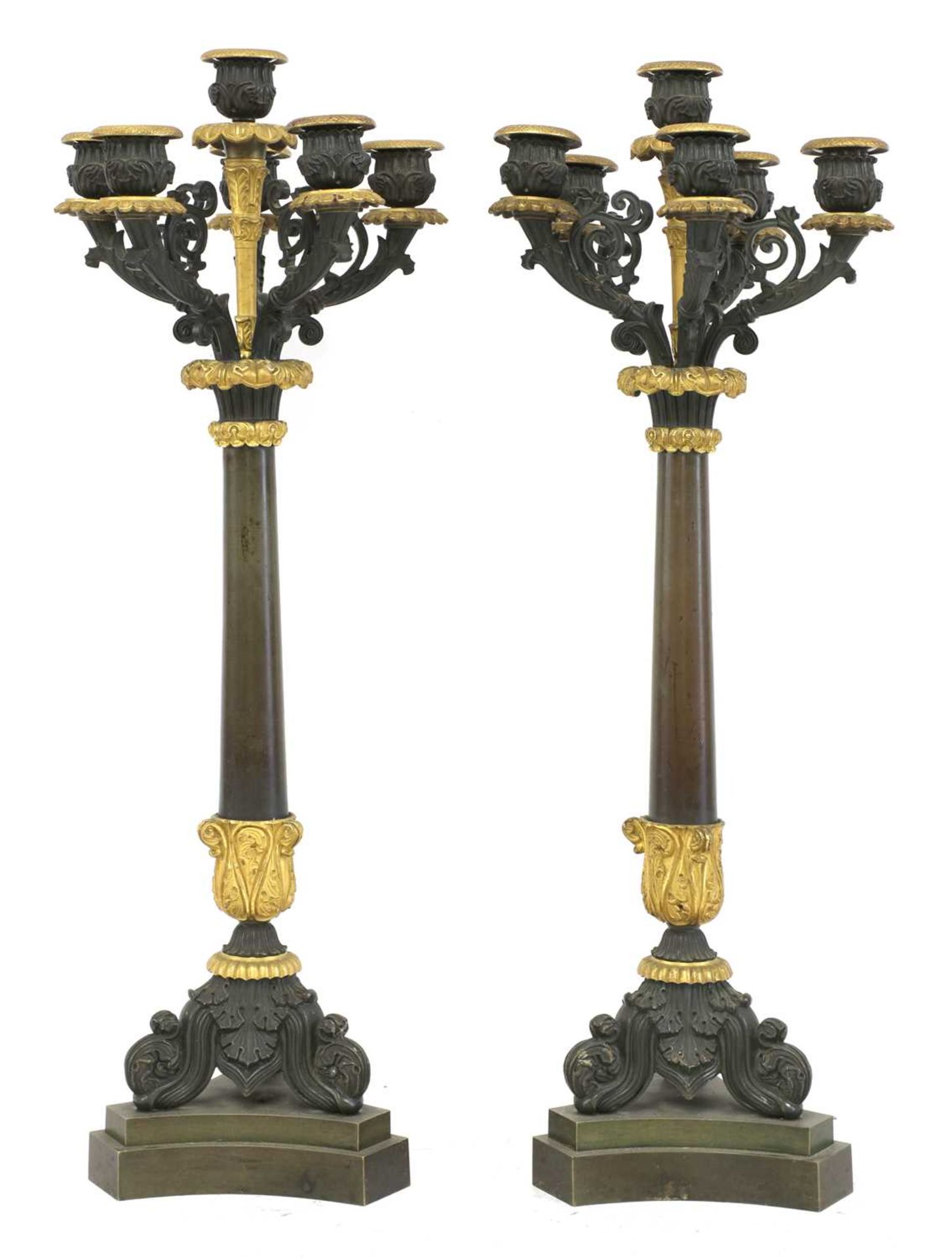 A pair of French Empire bronze and parcel gilt candelabrum,