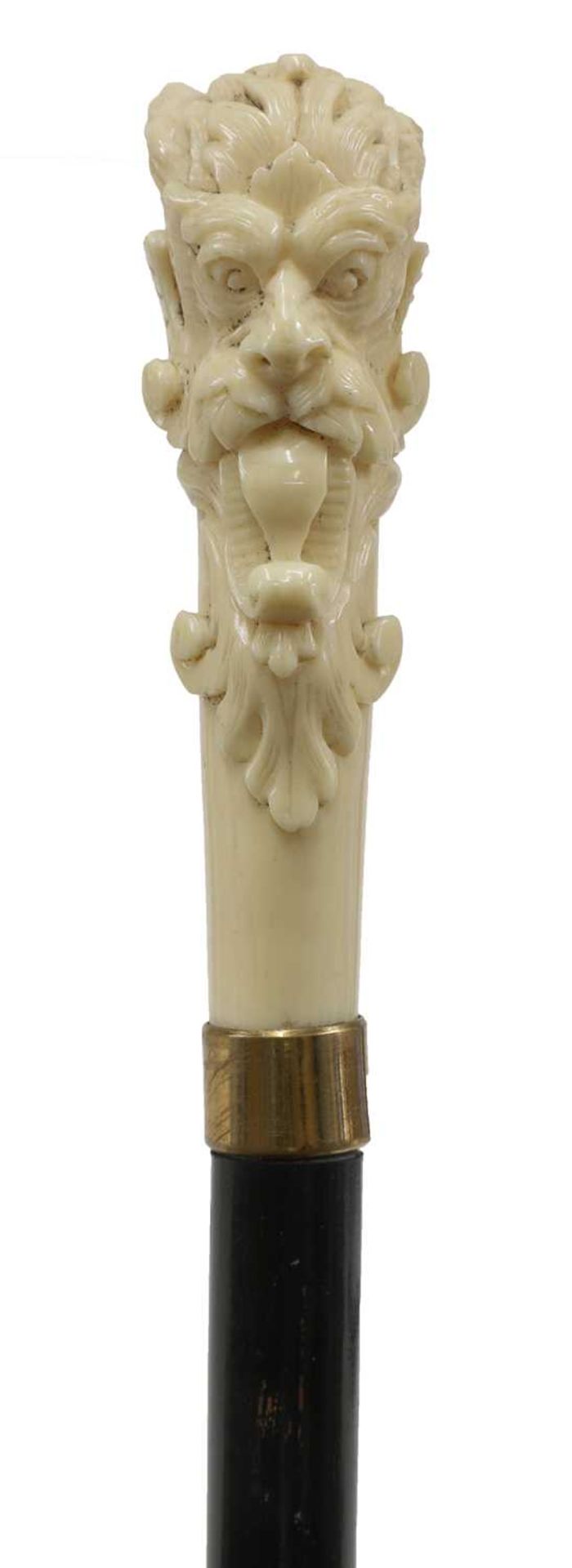 An ivory and ebonised walking stick,