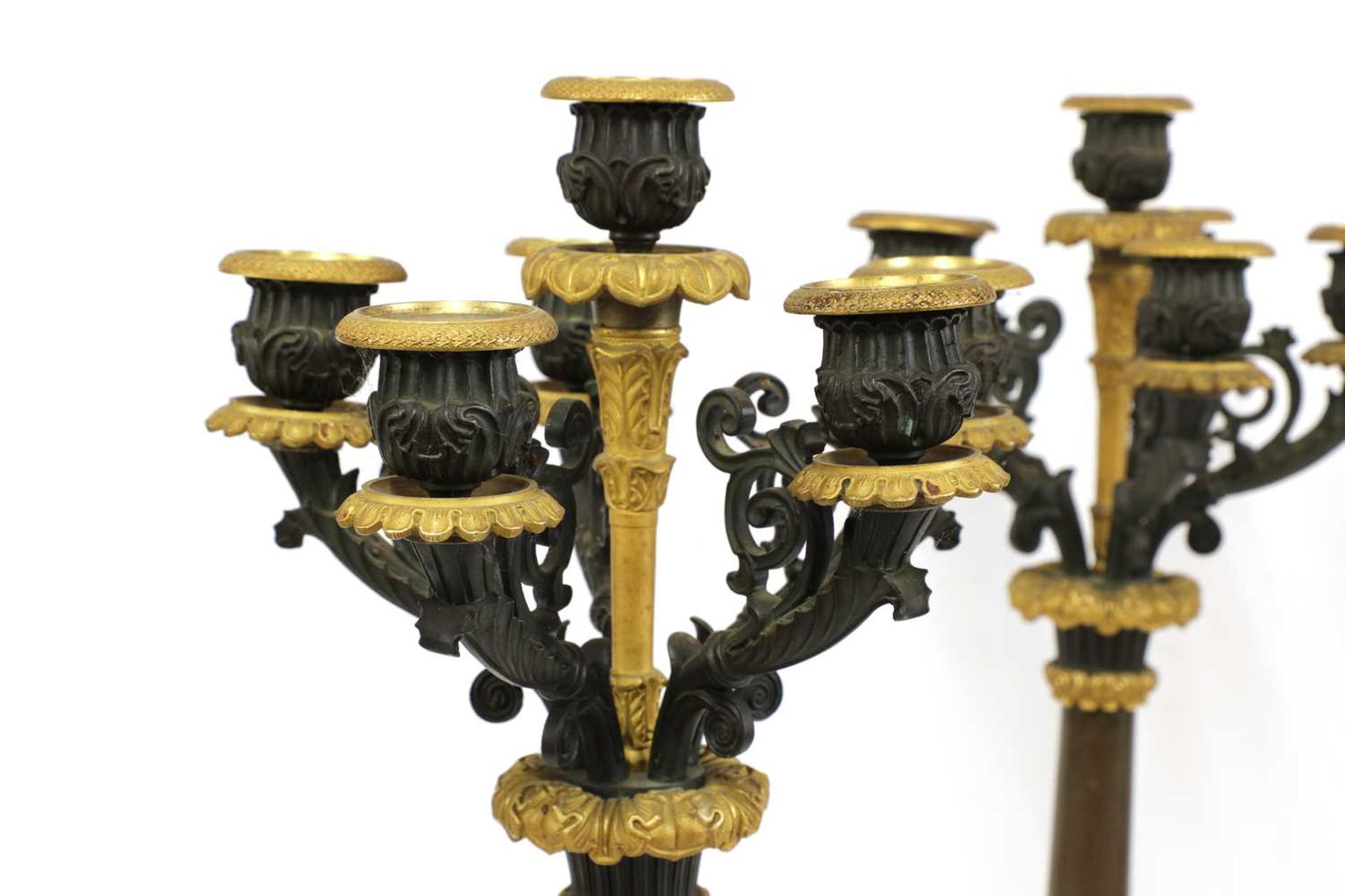 A pair of French Empire bronze and parcel gilt candelabrum, - Bild 2 aus 3