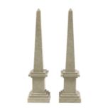 A pair of grey flecked marble obelisks