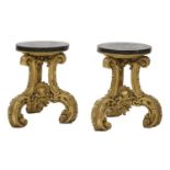 A pair of ornately carved giltwood stands