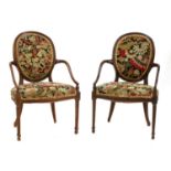 An elegant pair of Hepplewhite Revival elbow chairs,